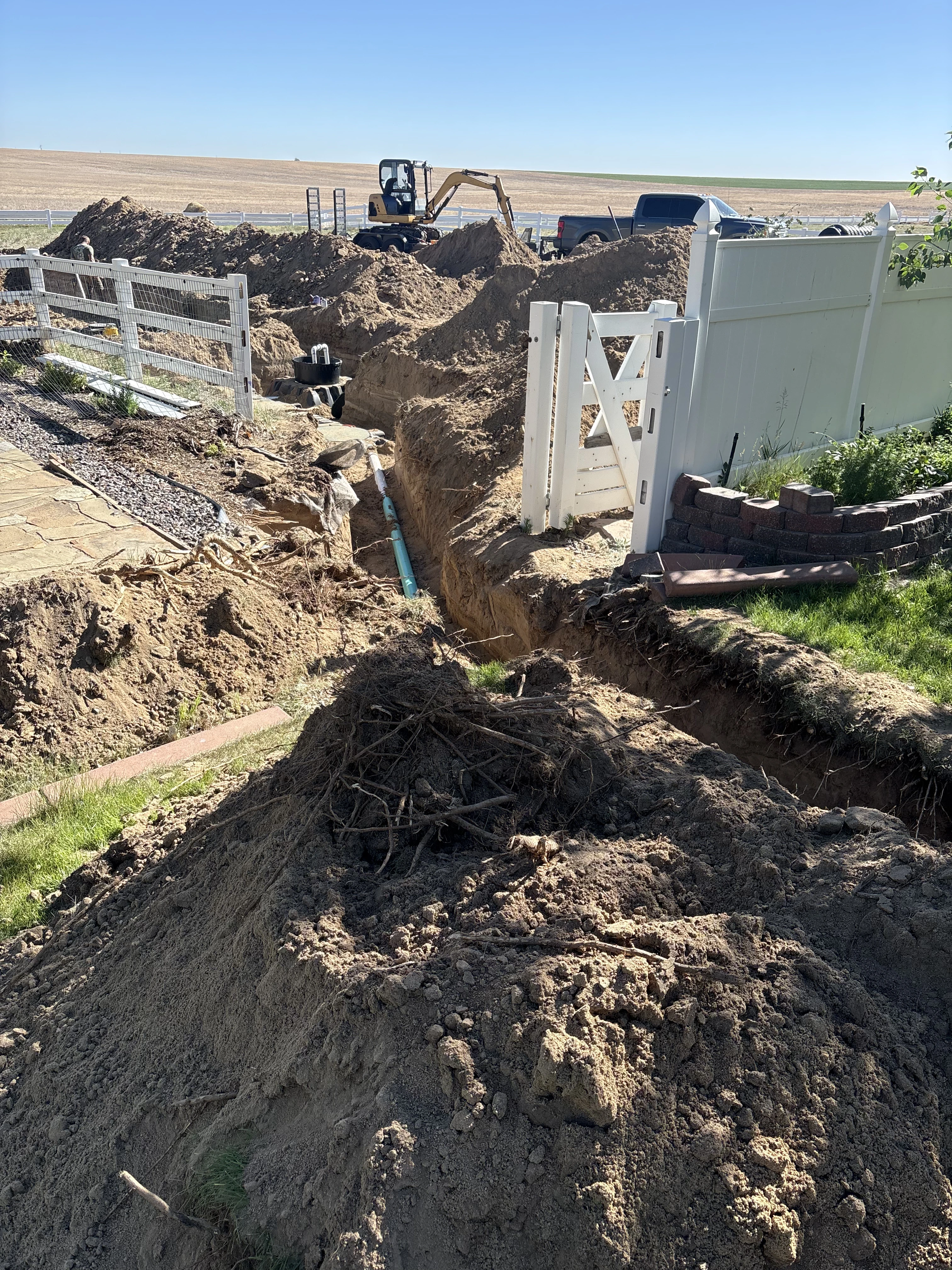 Mini excavator digging septic trench in Erie Colorado