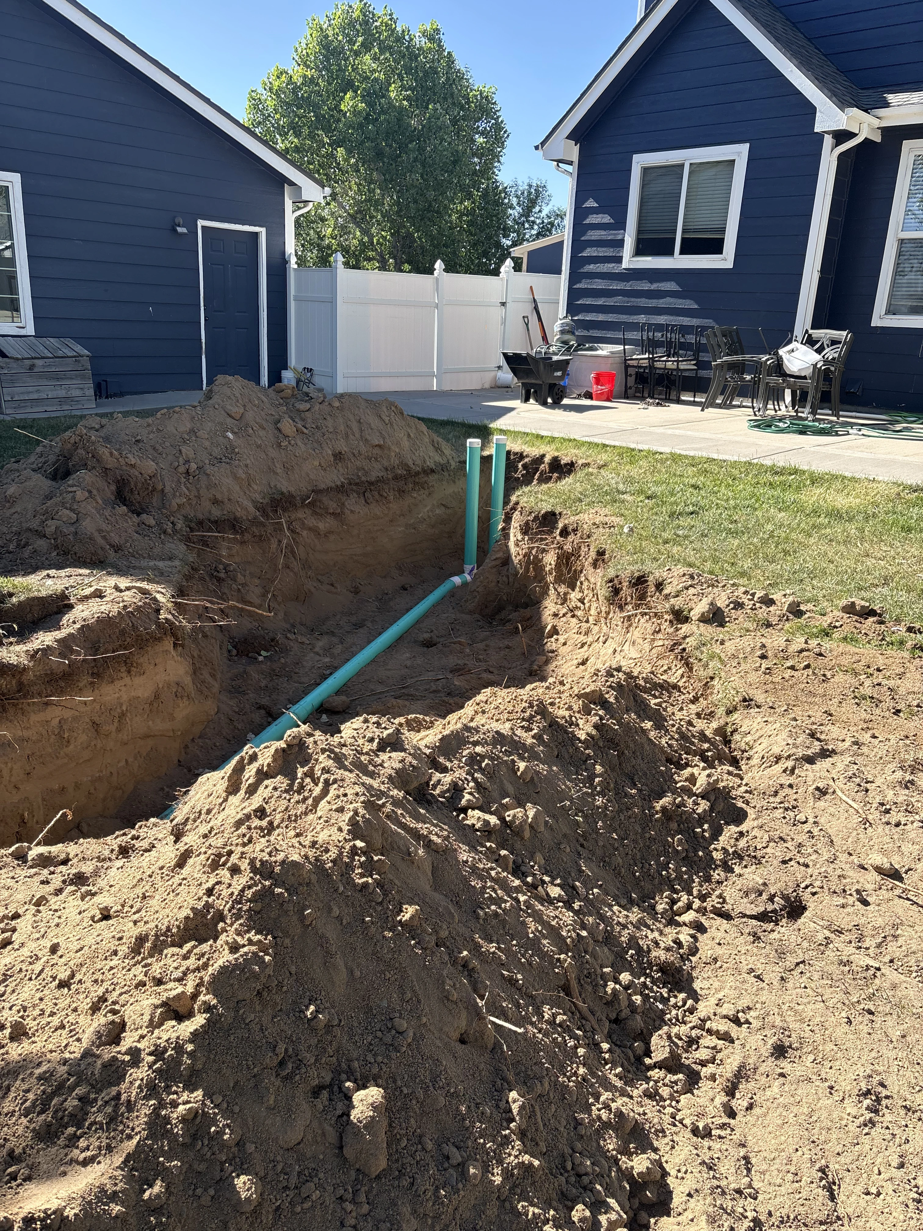 Finished drain field grading with green inspection cleanouts in Erie