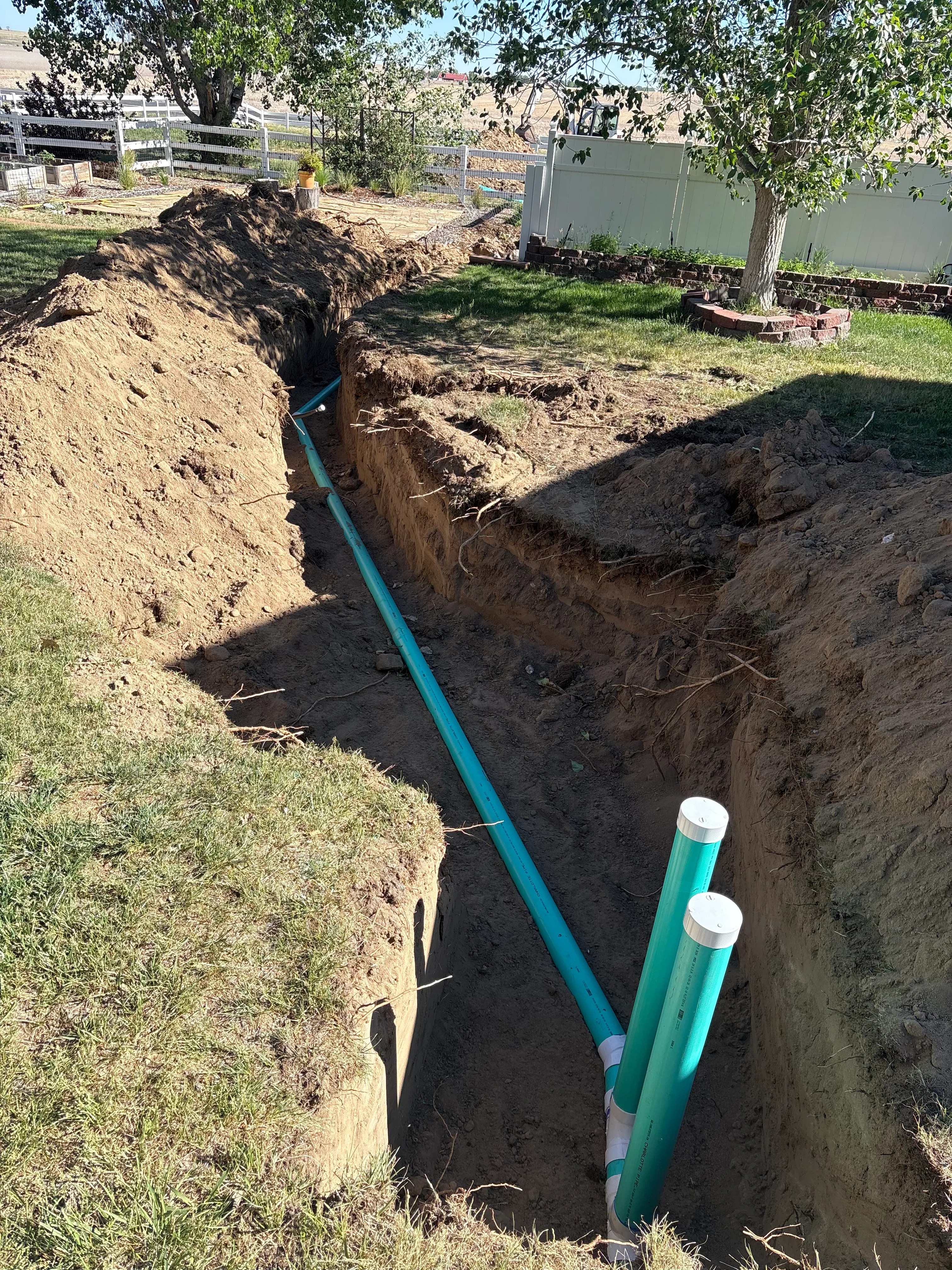 Deep sewer trench excavation with vertical two-way cleanouts in Longmont Colorado
