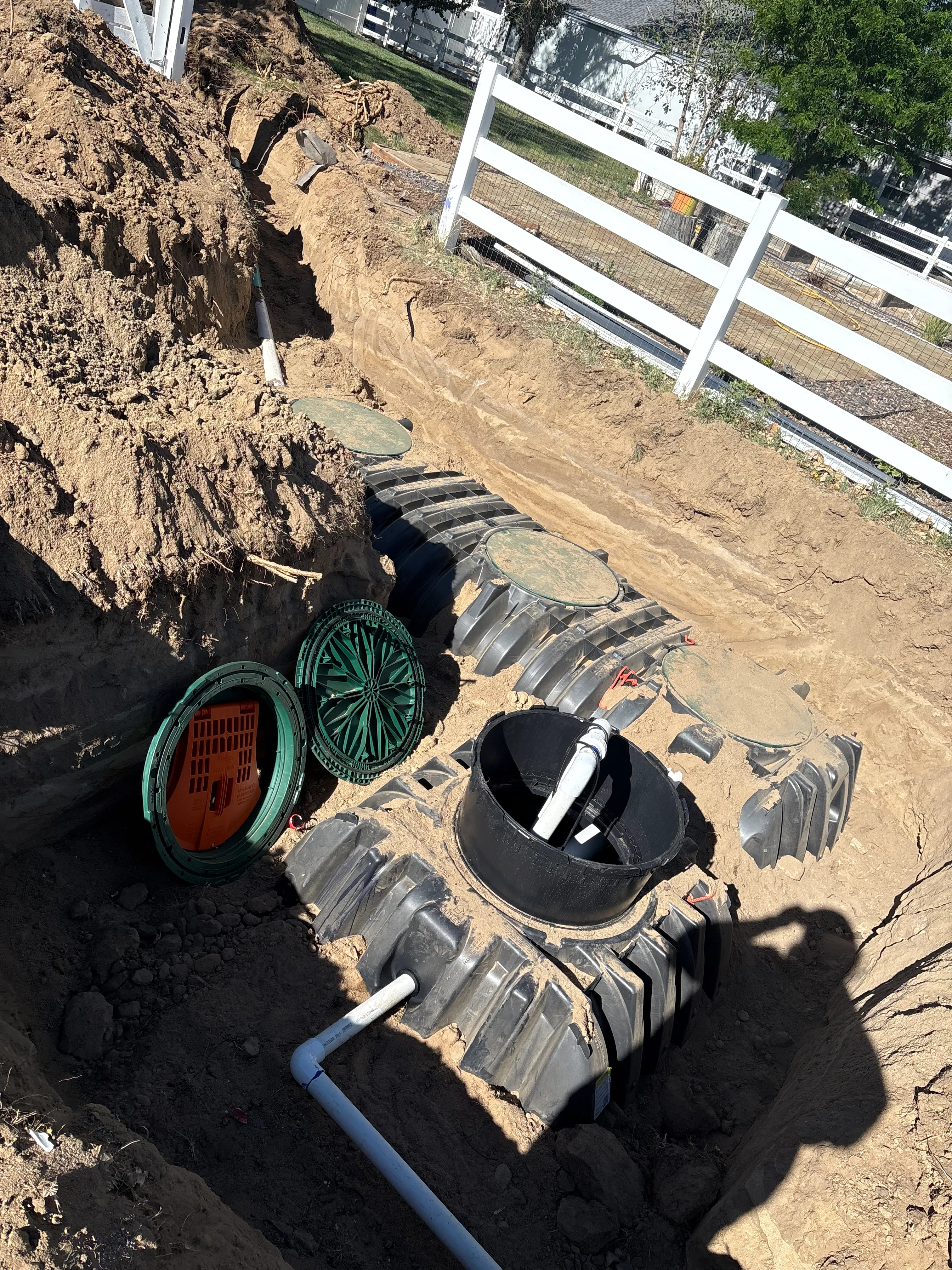 Heavy duty polyethylene septic tank setting with green access risers in Niwot Colorado